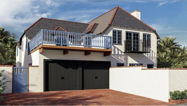 58 Saint Malo Bch, Oceanside, CA 92054 - rear view of property with fence, a balcony, stucco siding, an attached garage, and decorative driveway