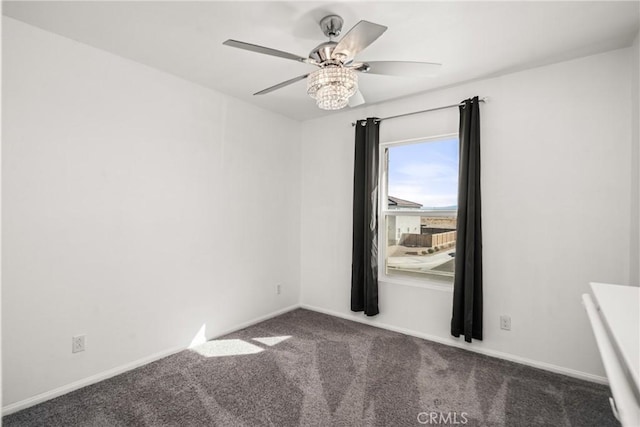 empty room featuring ceiling fan and dark colored carpet