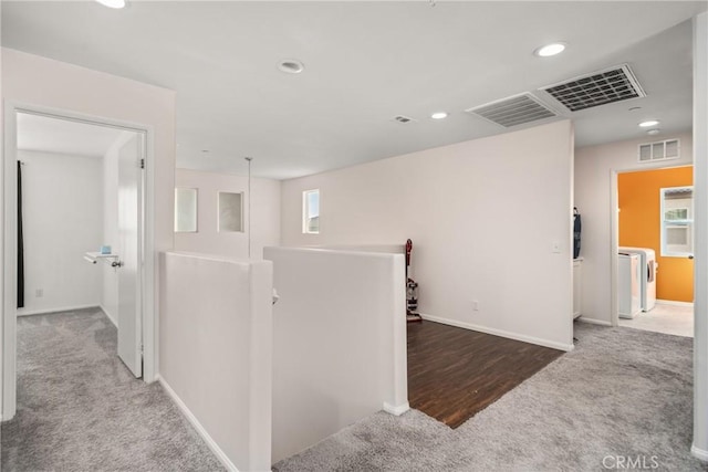 corridor featuring carpet flooring and washer / clothes dryer