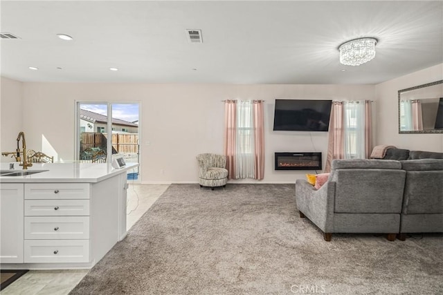 carpeted living room featuring sink