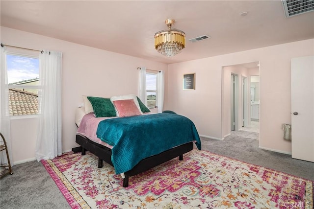 bedroom with light carpet and multiple windows