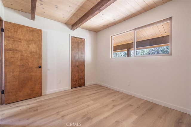 unfurnished bedroom with beam ceiling, wooden ceiling, baseboards, and wood finished floors