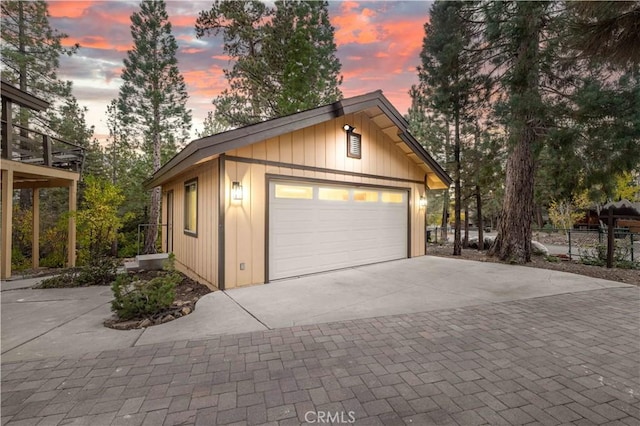 view of garage at dusk