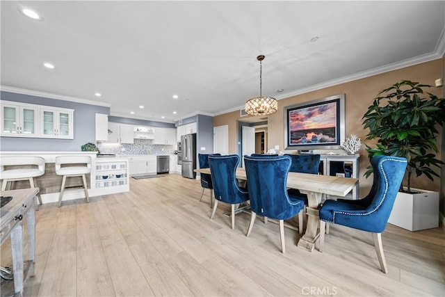 4344 Tradewinds Dr, Oxnard, CA 93035 - dining room with light wood-type flooring, crown molding, recessed lighting, and a chandelier