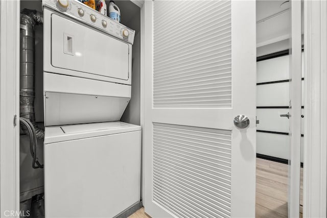4344 Tradewinds Dr, Oxnard, CA 93035 - washroom with stacked washing machine and dryer and light wood-type flooring