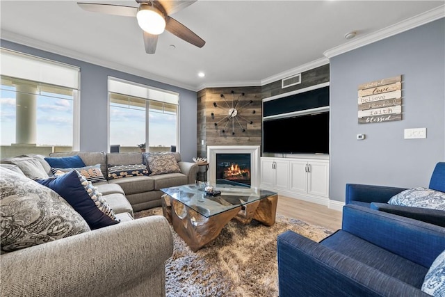 4344 Tradewinds Dr, Oxnard, CA 93035 - living area with crown molding, wood finished floors, a ceiling fan, a glass covered fireplace, and recessed lighting