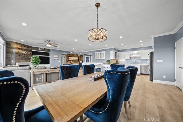 4344 Tradewinds Dr, Oxnard, CA 93035 - dining area with recessed lighting, ceiling fan, crown molding, light wood-type flooring, and a fireplace