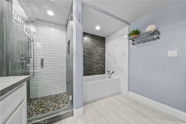 4344 Tradewinds Dr, Oxnard, CA 93035 - bathroom featuring a bath, a shower stall, vanity, baseboards, and tile patterned flooring