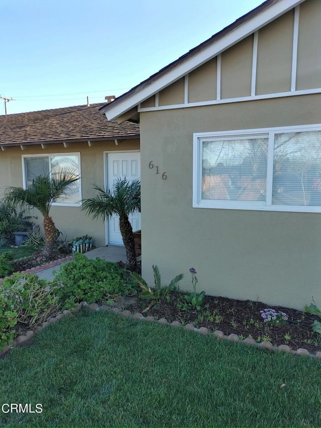 view of side of home with a lawn