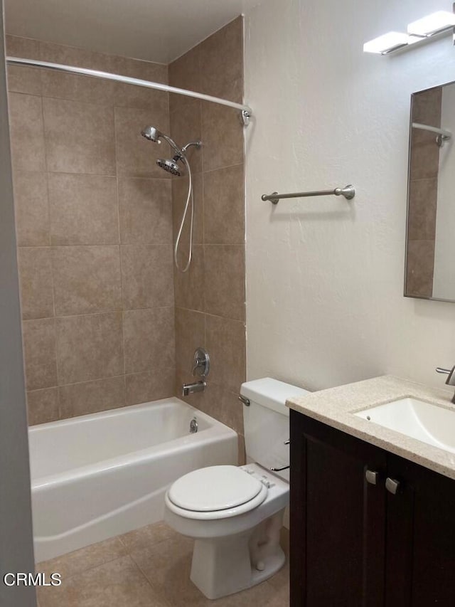 full bathroom with vanity, tiled shower / bath, toilet, and tile patterned flooring