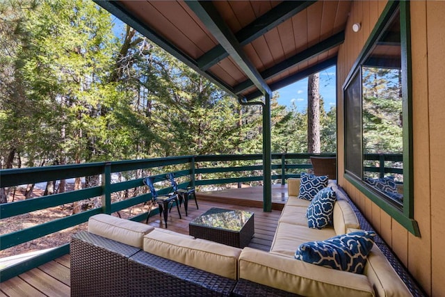 exterior space featuring a wooden deck and an outdoor hangout area