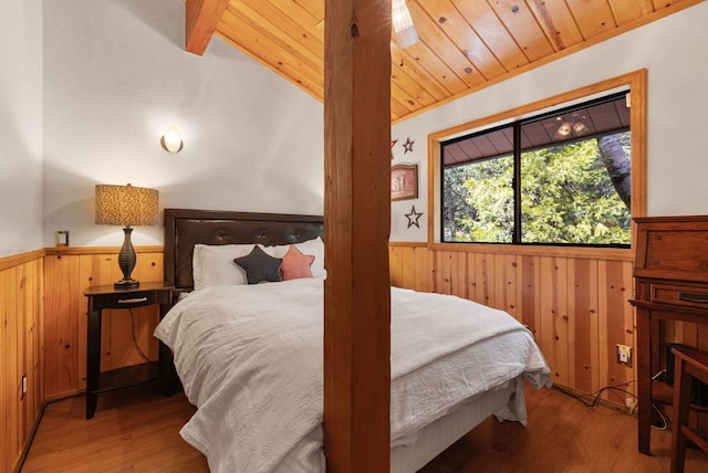 bedroom featuring wood ceiling, hardwood / wood-style floors, and vaulted ceiling with beams