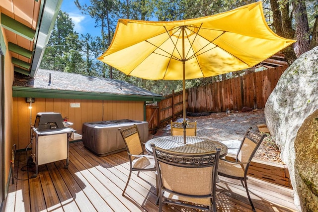 wooden terrace featuring area for grilling and a hot tub