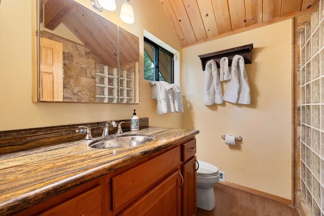 bathroom with vaulted ceiling, wood-type flooring, vanity, toilet, and wooden ceiling