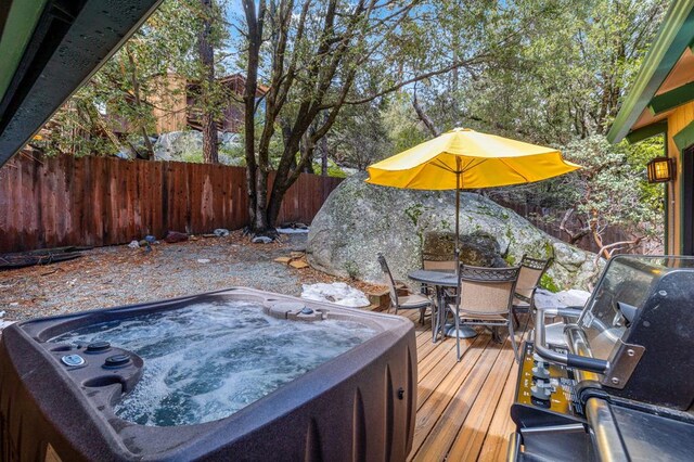 wooden terrace featuring a hot tub