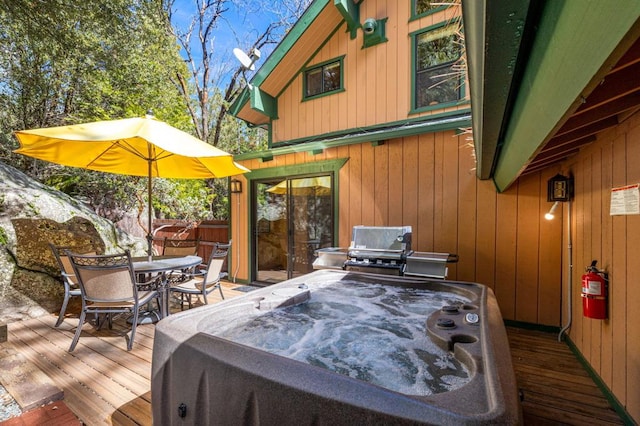 wooden deck featuring a hot tub