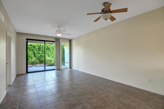 empty room featuring ceiling fan and tile patterned floors