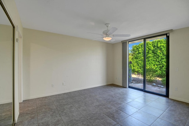 tiled spare room featuring ceiling fan