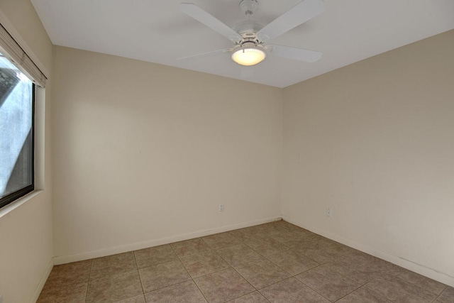 tiled empty room featuring ceiling fan