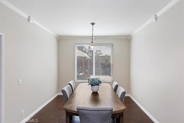 dining area with dark wood-type flooring, crown molding, and baseboards