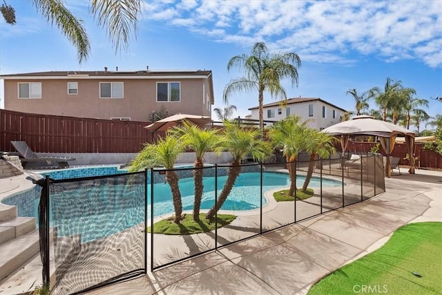 view of pool with a fenced backyard, a patio, a fenced in pool, and a gazebo