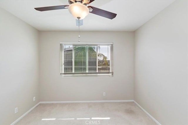 empty room with light carpet, ceiling fan, and baseboards