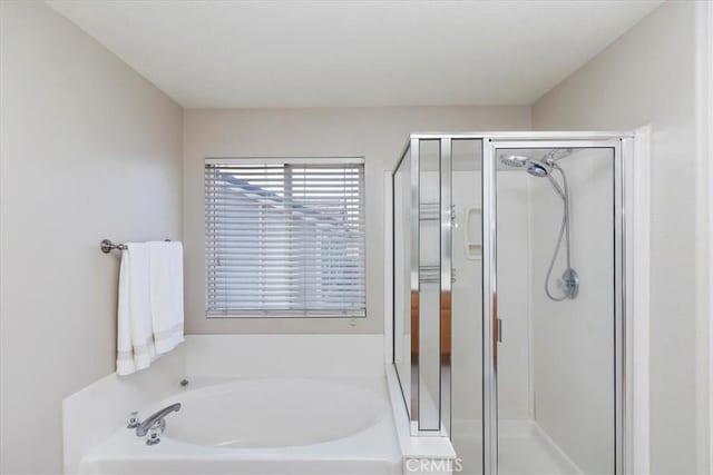 bathroom with a garden tub and a shower stall