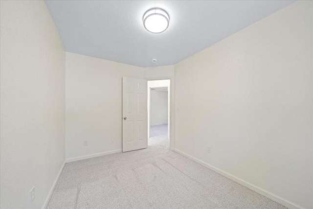 spare room with light colored carpet