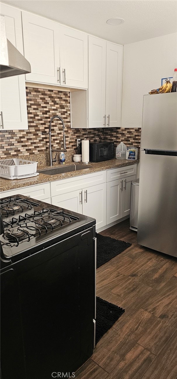 kitchen featuring white cabinetry, black appliances, sink, and dark hardwood / wood-style floors