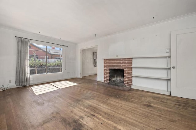 unfurnished living room with a fireplace, wood-type flooring, and crown molding