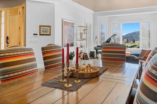 sitting room featuring wood-type flooring and crown molding