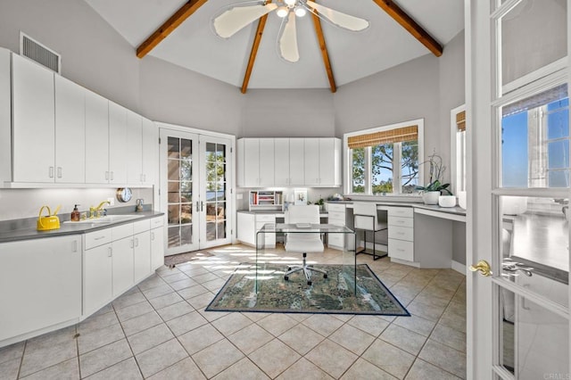 kitchen with white cabinetry, sink, french doors, beamed ceiling, and high vaulted ceiling