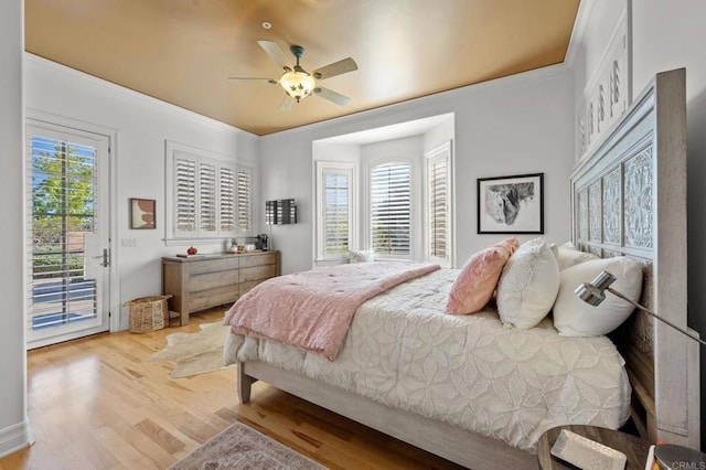 bedroom featuring access to exterior, ceiling fan, light hardwood / wood-style flooring, and crown molding