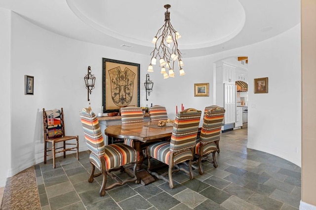 dining space with a tray ceiling