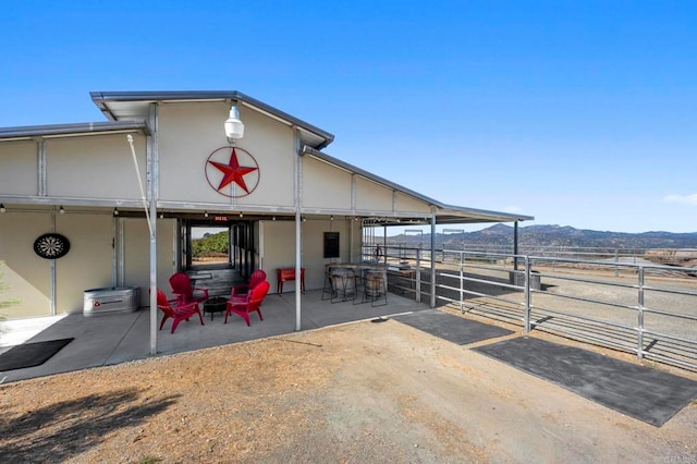 view of patio / terrace with a mountain view and an outdoor structure