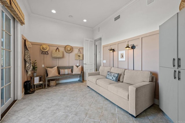 tiled living room featuring a high ceiling and crown molding