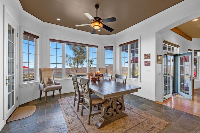 dining room featuring ornamental molding, ceiling fan, and a healthy amount of sunlight