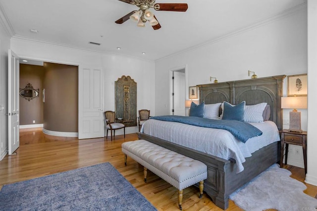 bedroom with ceiling fan, light wood-type flooring, and ornamental molding