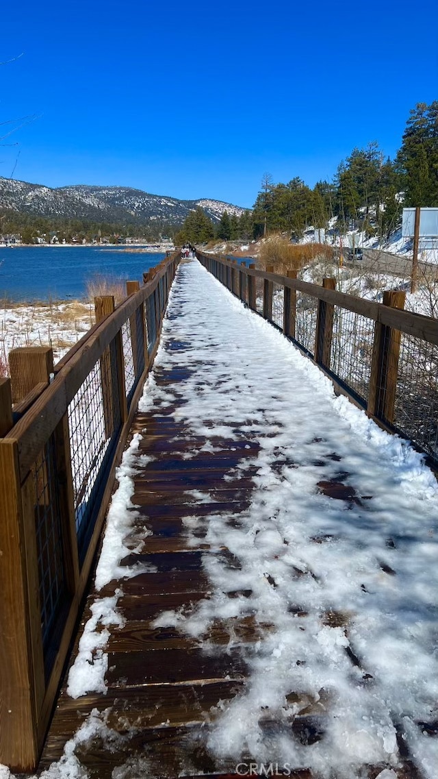 view of dock featuring a water and mountain view