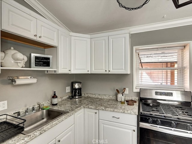 kitchen with crown molding, stainless steel range with gas cooktop, sink, and white cabinets