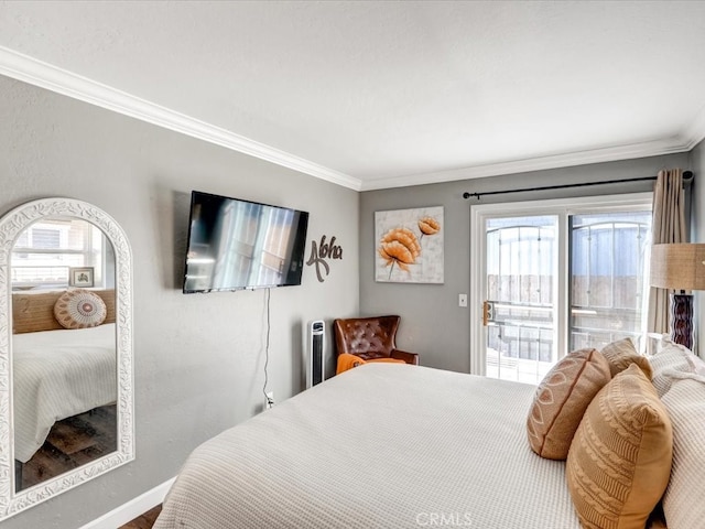 bedroom featuring access to outside, multiple windows, and ornamental molding