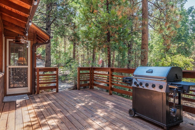 wooden deck featuring a grill