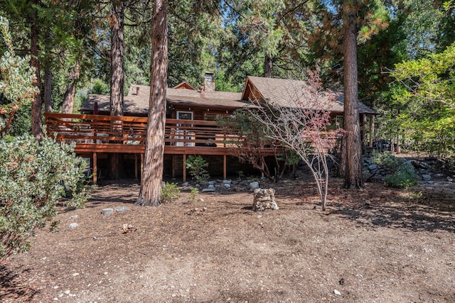 back of property with a wooden deck