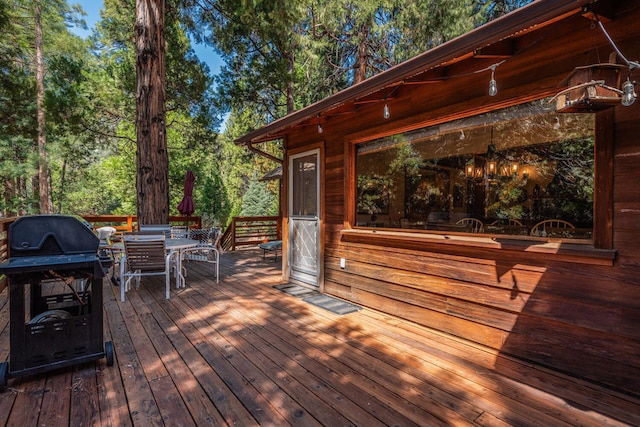 wooden terrace with area for grilling