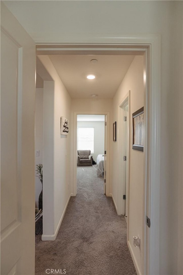 hallway featuring light colored carpet