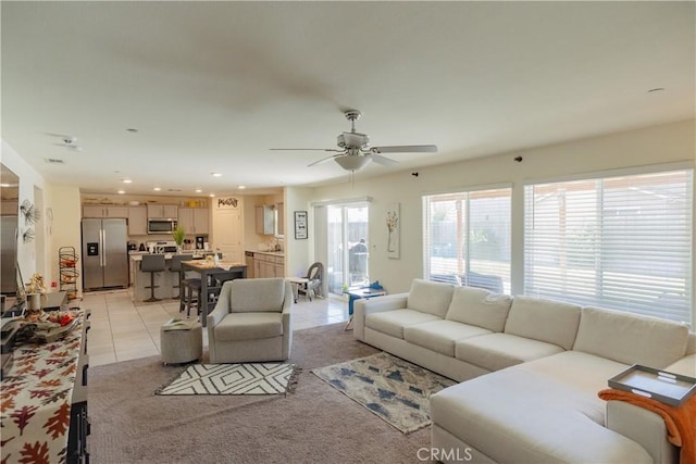 living room with ceiling fan and light tile patterned flooring