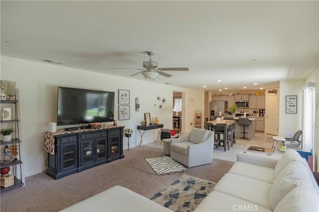 living room featuring light tile patterned floors, a wealth of natural light, and ceiling fan