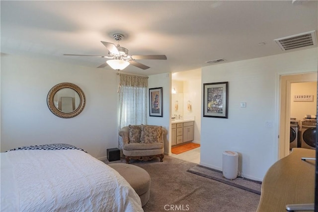 carpeted bedroom with separate washer and dryer, ceiling fan, and ensuite bathroom