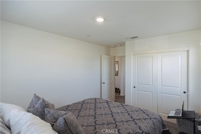 carpeted bedroom featuring a closet