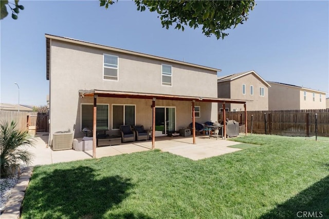 rear view of property featuring a patio area, a yard, and central AC